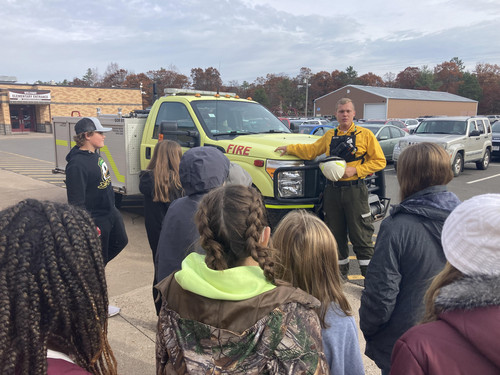 Volunteer Mr. Rider speaks with students about wildland firefighting.